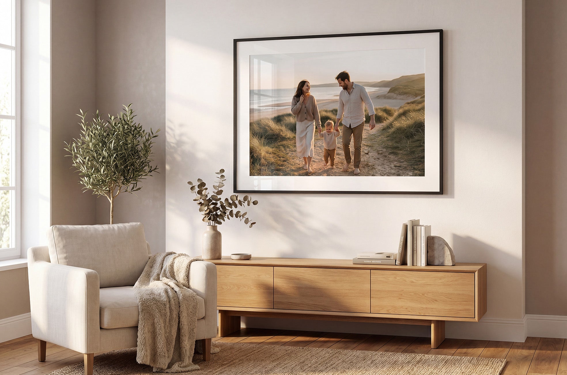 Living room with a family framed & mounted print on the wall above a wooden cabinet.