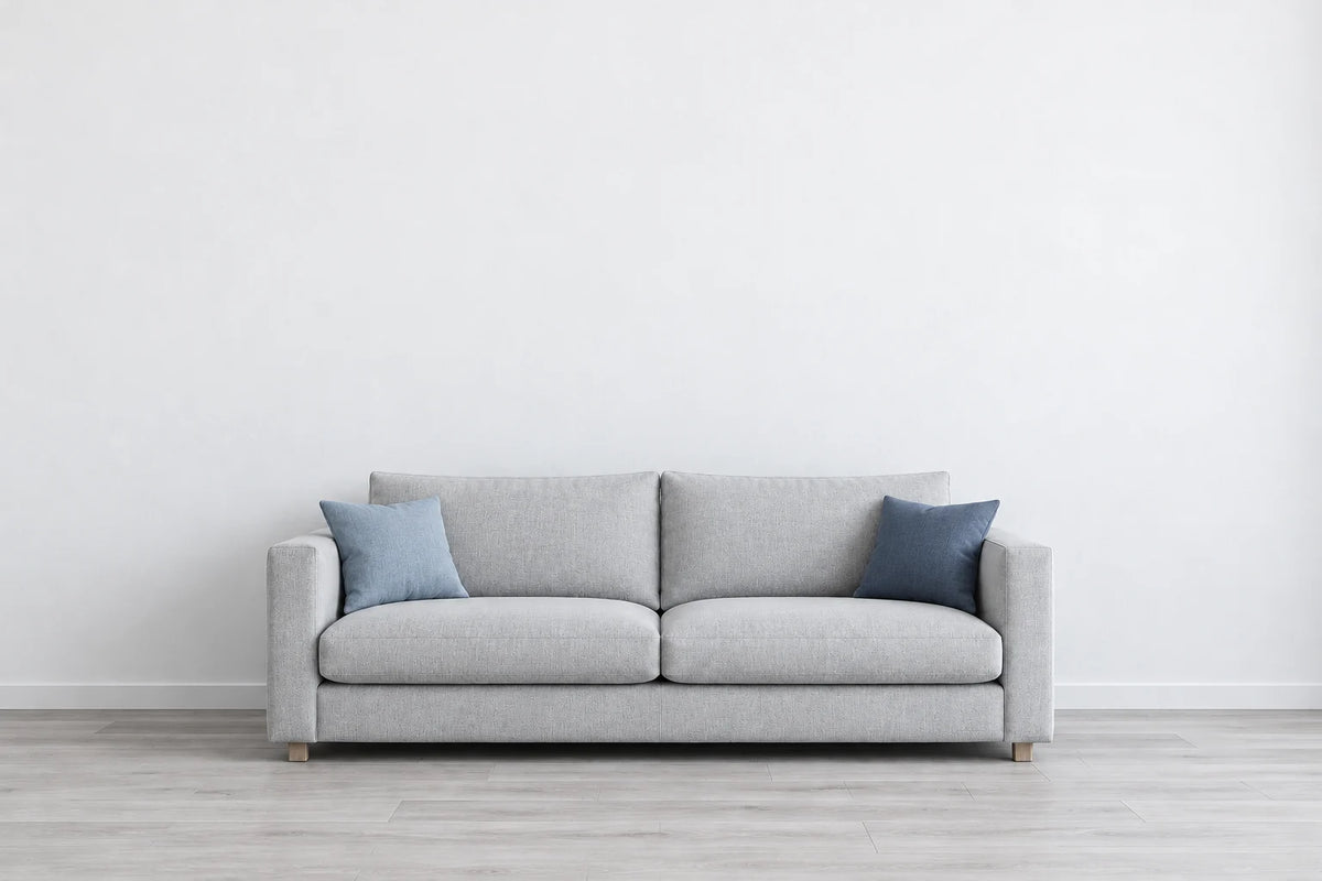 Illustrative light grey living room with a grey sofa and blue cushions