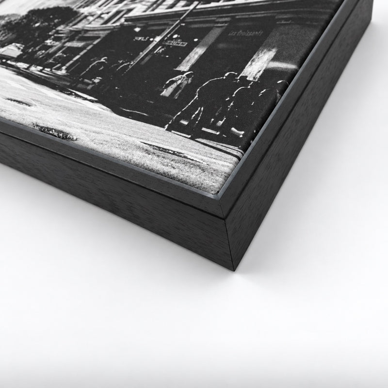 Close-up of a black floating framed canvas with a black-and-white street photograph