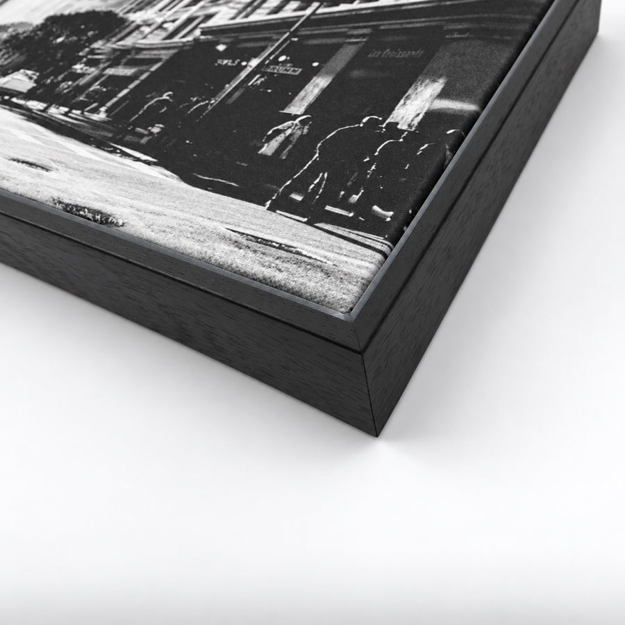 Close-up of a black floating framed canvas with a black-and-white street photograph