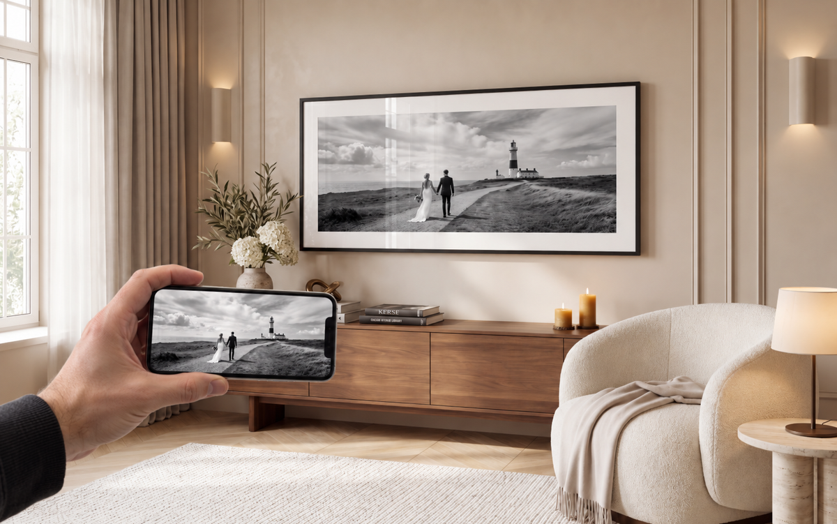 A wedding photo on a phone, displayed as a panoramic framed print in a living room