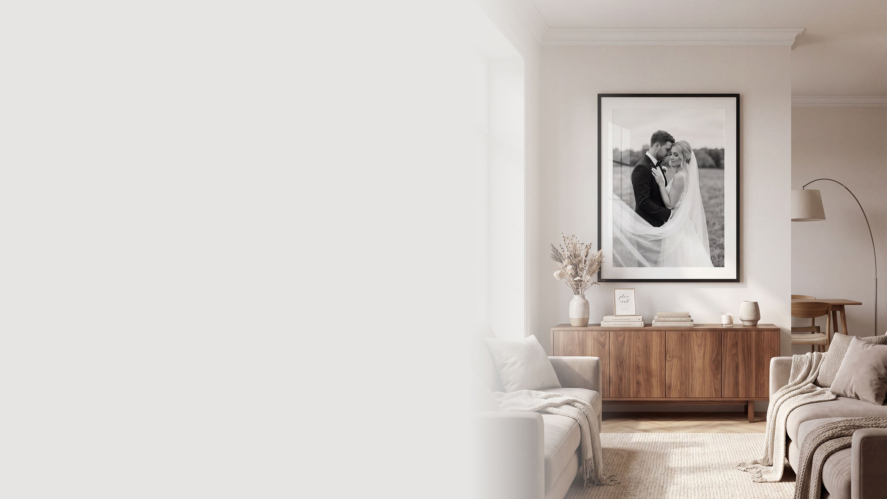 Modern living room with a black and white framed wedding photo on the wall.